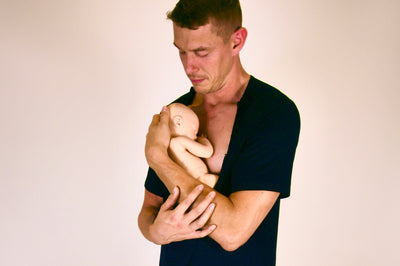 The Cameron skin to skin shirt in black, man holding baby